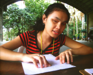 a girl reading braille book