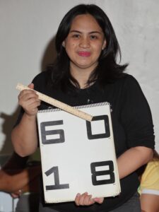 a lady holding a chart used in eye examinations